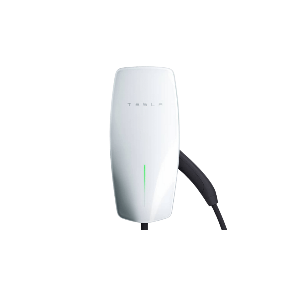 A white Tesla electric vehicle charger mounted on a wall with a sleek design and a cable attached. The charger has the Tesla logo and a green light indicator on the front.