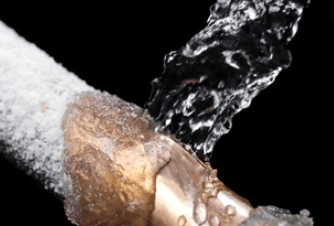 pouring warm water on condensate pipe